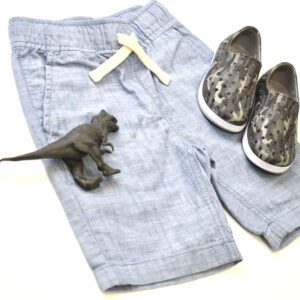 A blue color jean along with shoes and a toy