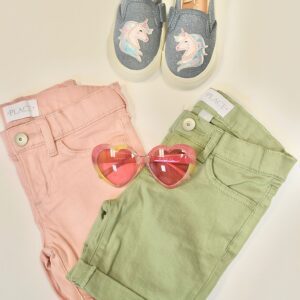 A pair of cloths along with sunglasses and shoes