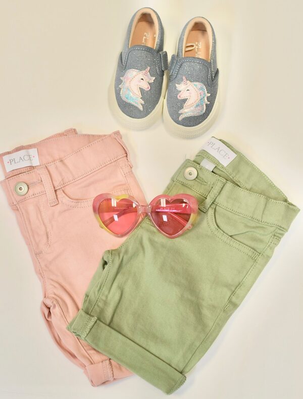 A pair of cloths along with sunglasses and shoes