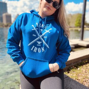 A girl wearing a blue sweat shirt near a lake