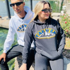 A couple wearing same hoodies posing at the camera